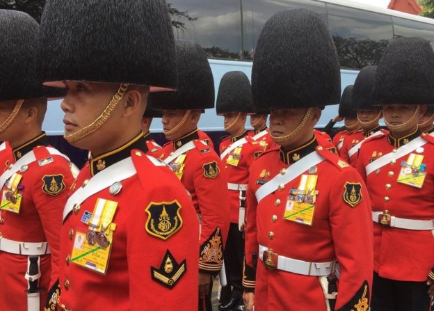 Солдаты одетые в церемониальных обмундированиях собирая вне большого дворца в Бангкоке 14-ого октября 2016